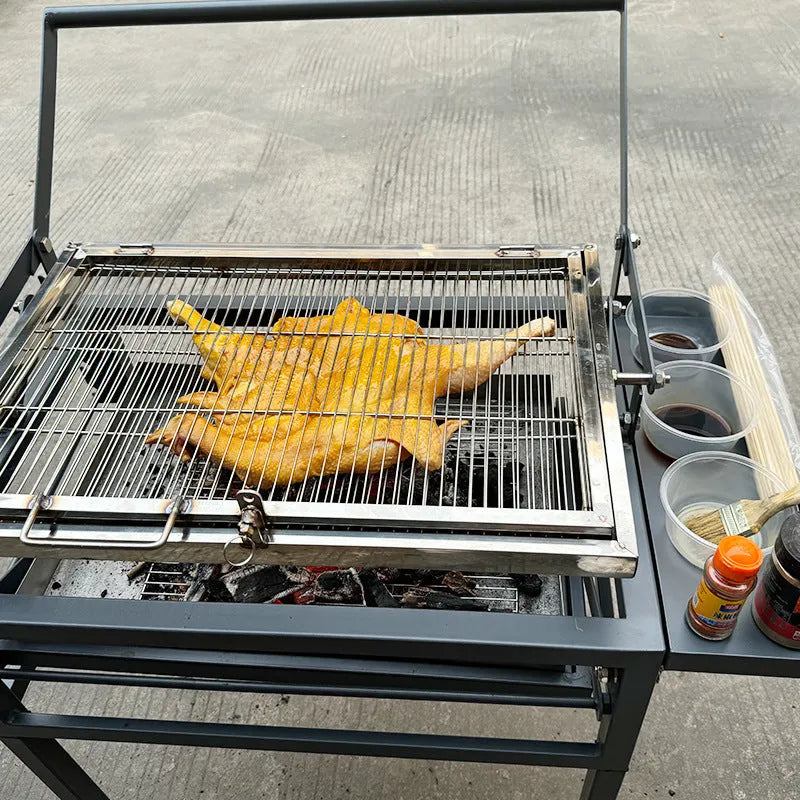 Large portable foldable charcoal barbecue grill stove shown in a garden setting