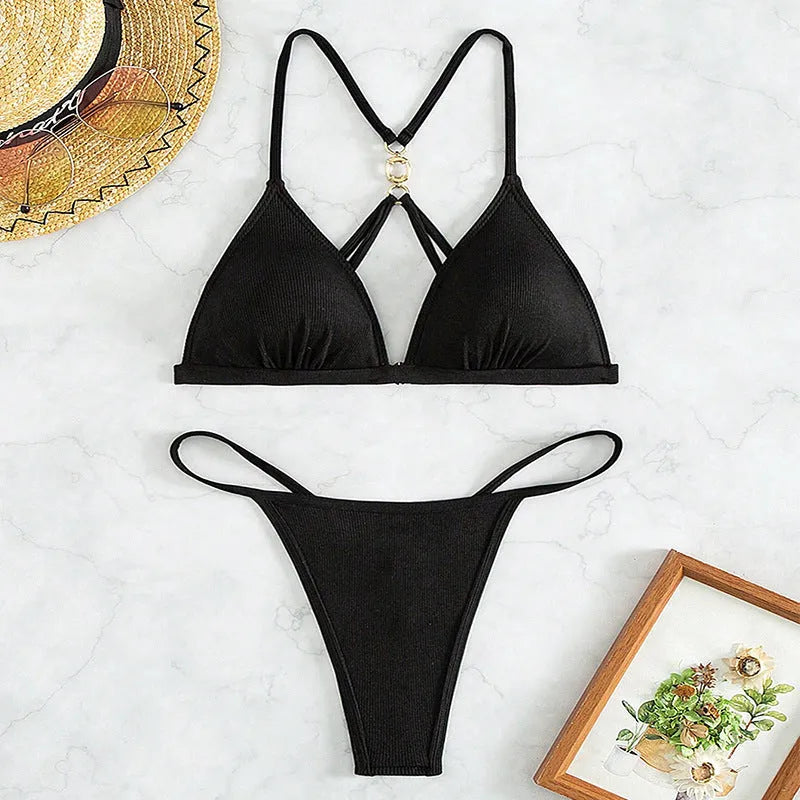 Black women's bikini set with hollow backless triangle top and matching pants.