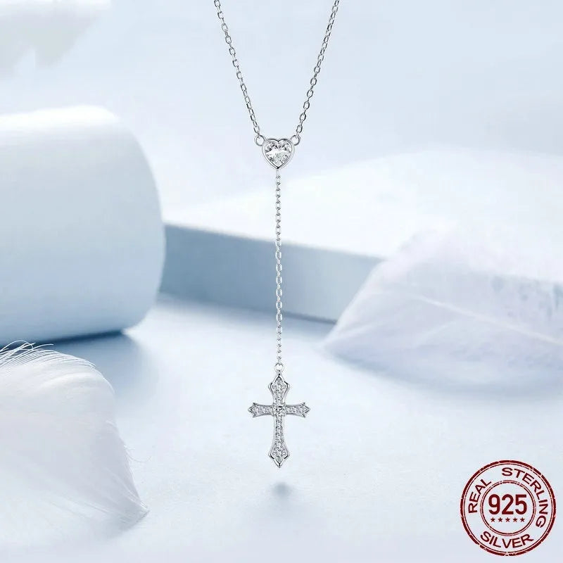 Women's silver cross necklace with V-neck design and O-ring chain.