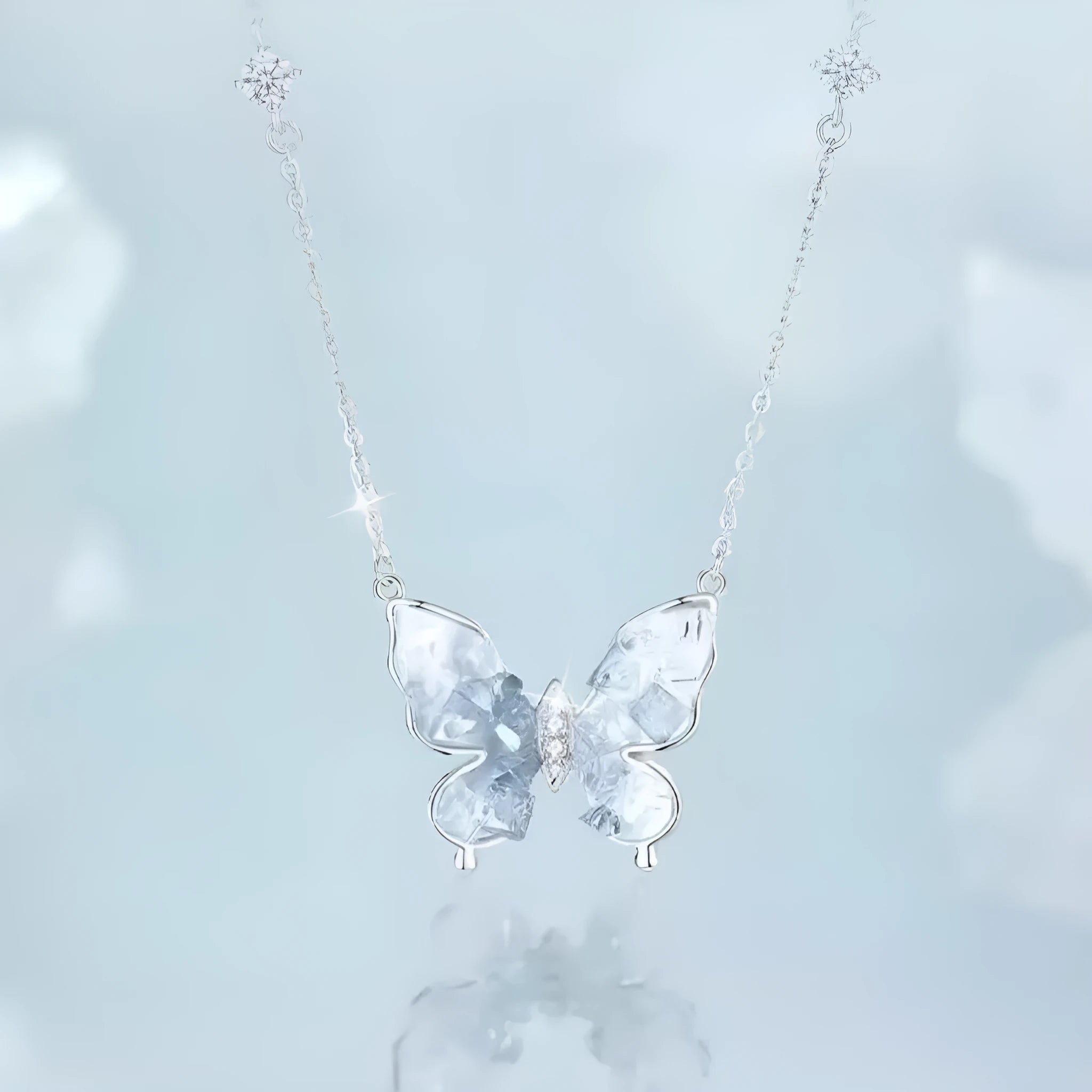 Close-up of a silver butterfly pendant necklace on an adjustable O-ring chain.