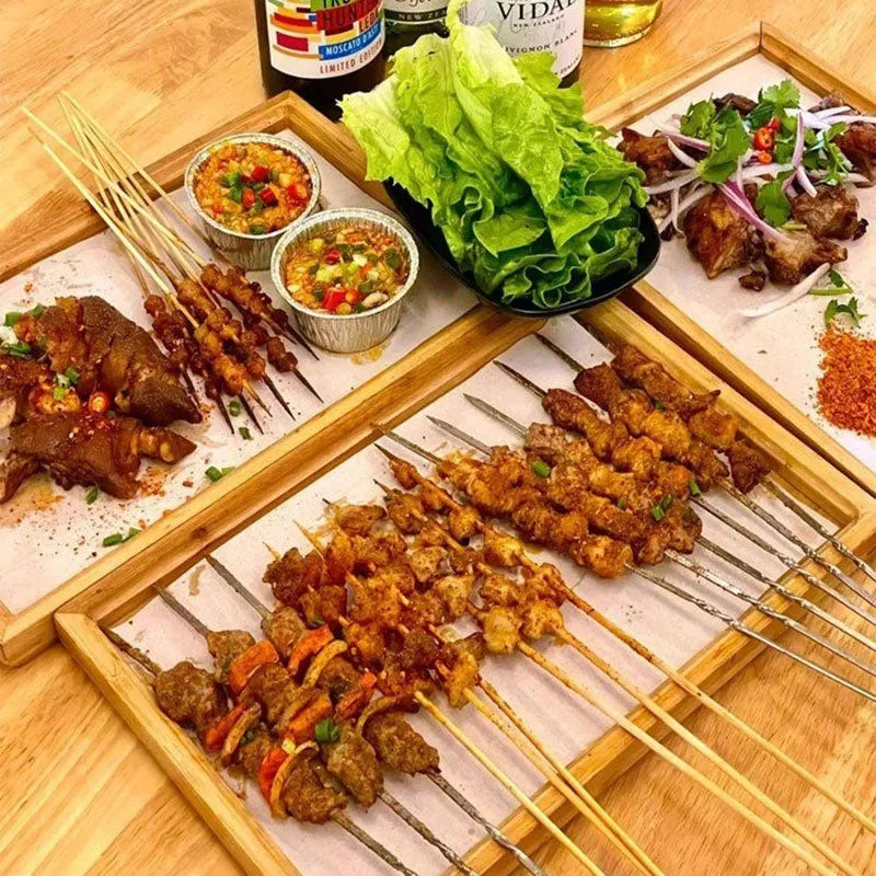 Square bamboo serving tray with brown handle on solid colour background