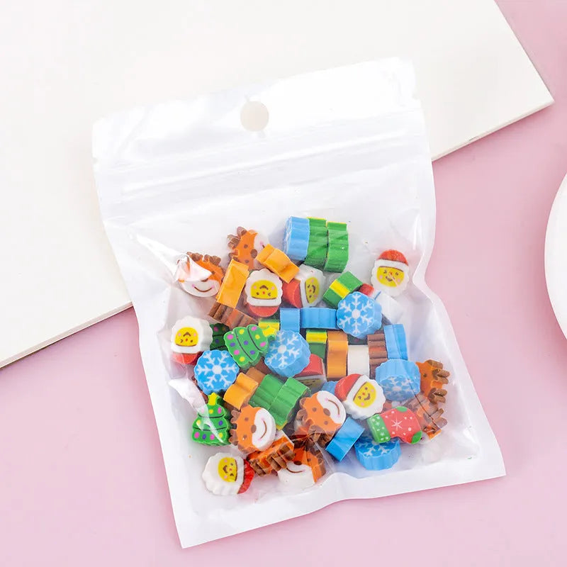 Open pearlescent film bag showing 50 small colourful cartoon fruit-themed rubber erasers.