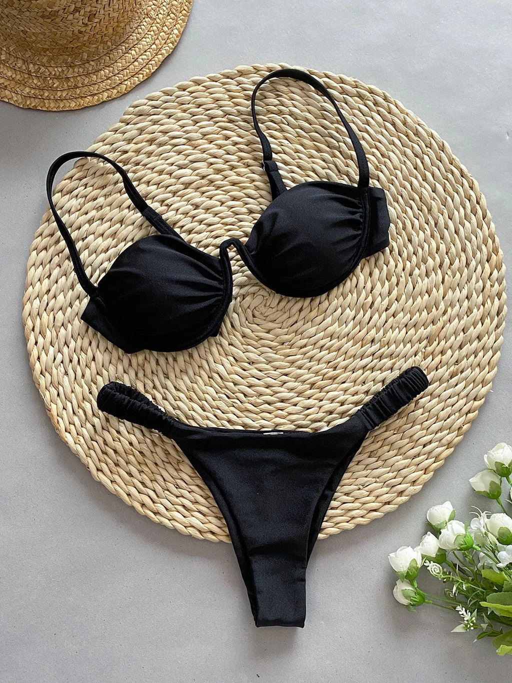 Women's black underwire bikini swimsuit with briefs style on a mannequin.