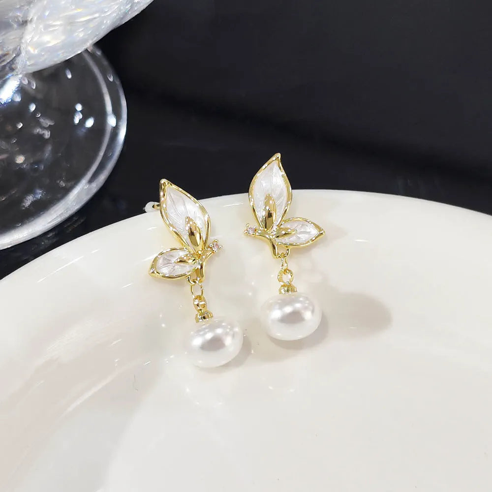 Butterfly-shaped drop earrings for women with oil painting design and zircon stone accents on copper.