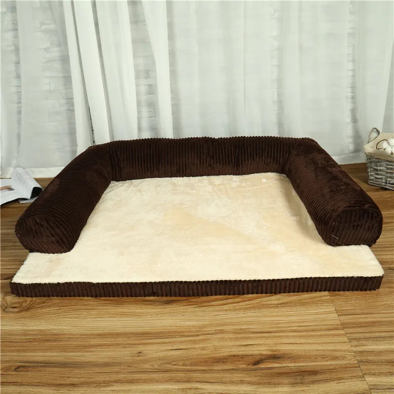 Corduroy dog sofa bed with bolster sides in a grey colour, shown on a wooden floor.