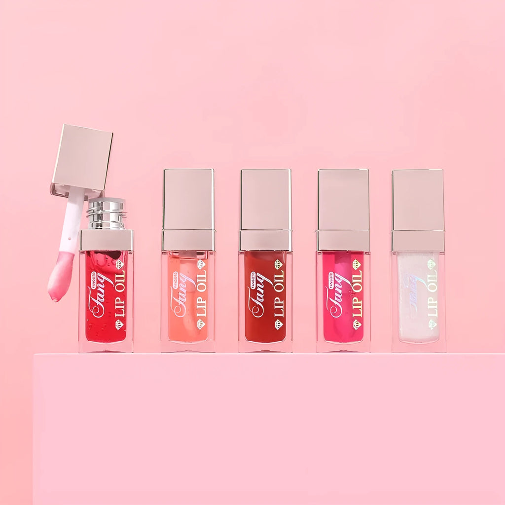 Mint lip essence oil tube in one of five bright colours, shown as a dual-use lip gloss and lipstick.