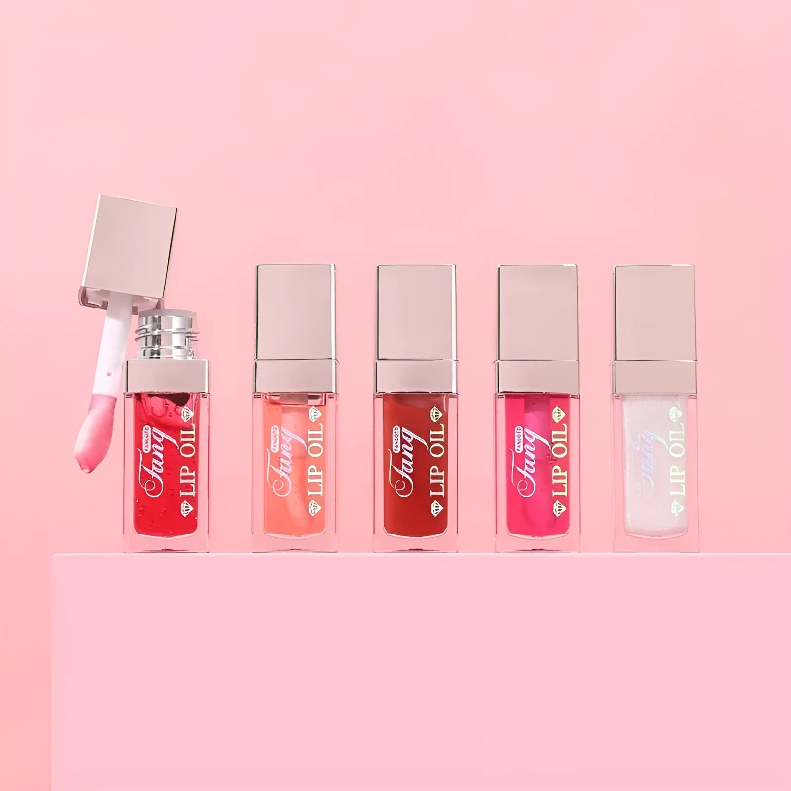Mint lip essence oil tube in one of five bright colours, shown as a dual-use lip gloss and lipstick.