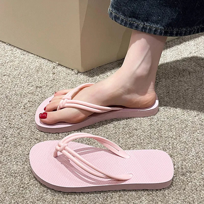 Women's pink PVC closed-toe flip flops with a non-slip sole on a plain background.