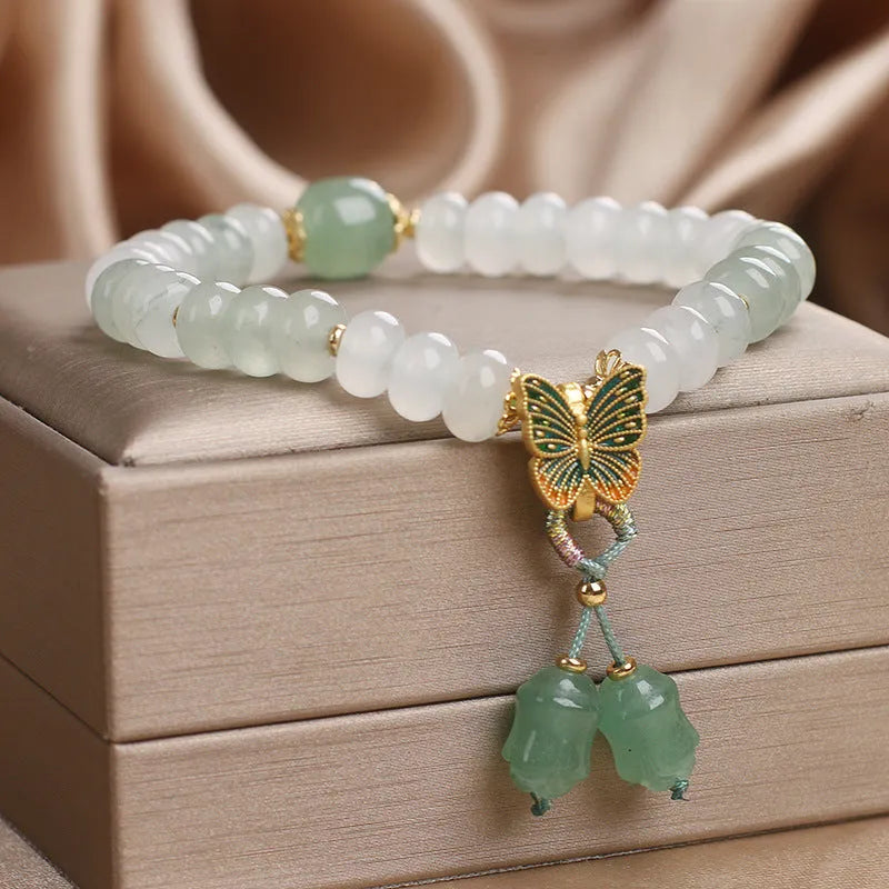 Green abacus bead bracelet for women with a butterfly tassel, pearls, and rhinestones
