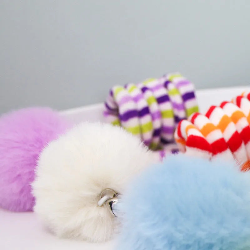 Spring cat toy with inflatable ball and bell hanging from suction cup stick in multiple colour options