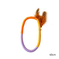 Circular green cotton rope cat toy with feathers and catnip for interactive play