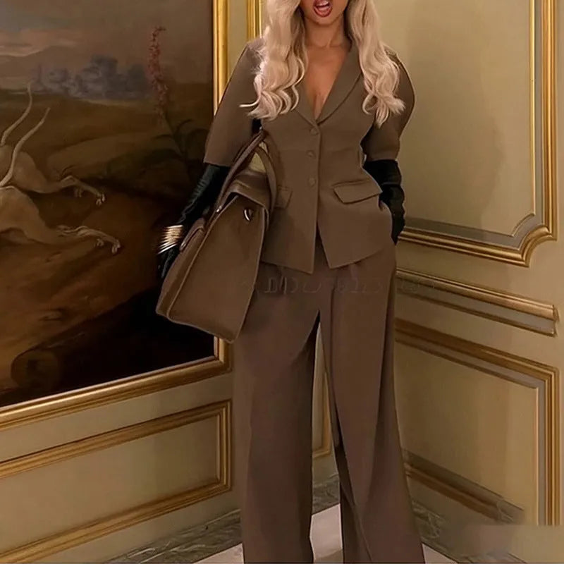 Brown slim fit two-piece polyester suit on a hanger, showing the long sleeve top and trousers.