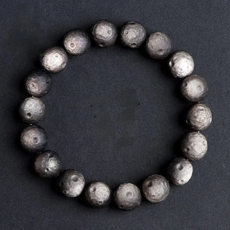 Obsidian crater ball bracelet with natural grinding texture in silver stone meteorite colour