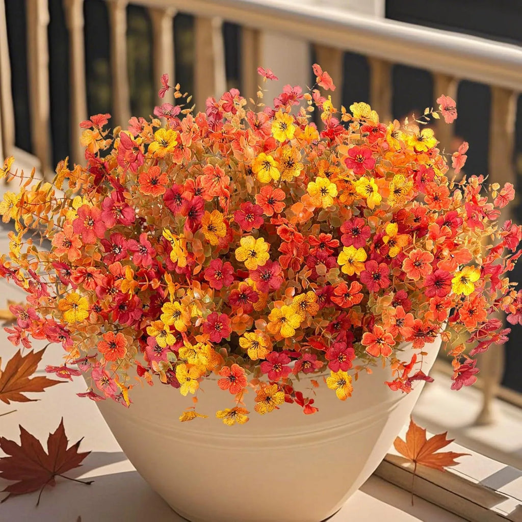 Artificial silk flower bouquet in autumn colours on a plastic stem for home and event decoration.