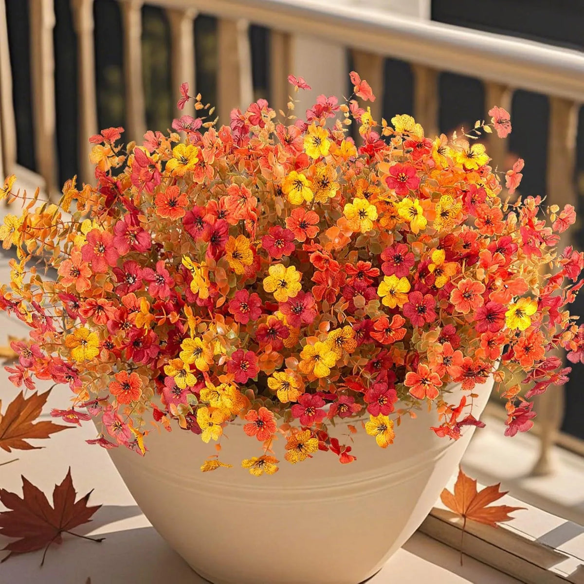 Artificial silk flower bouquet in autumn colours on a plastic stem for home and event decoration.