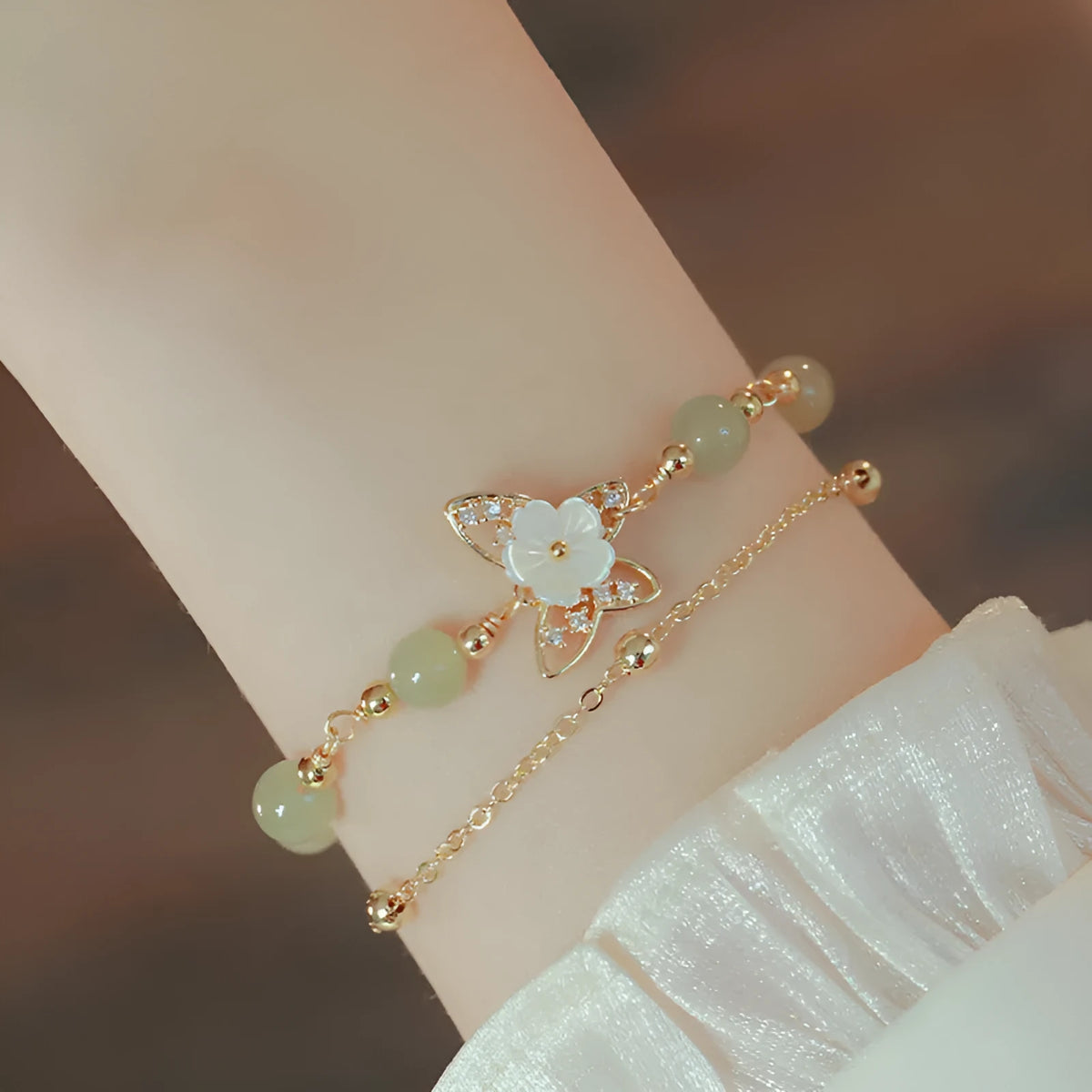 Yellow gold butterfly bracelet on copper base with geometric shape.