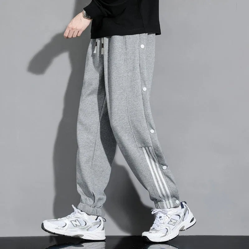 Men's loose fit ankle-tied sports pants in black with drawstring waist and elastic cuffs