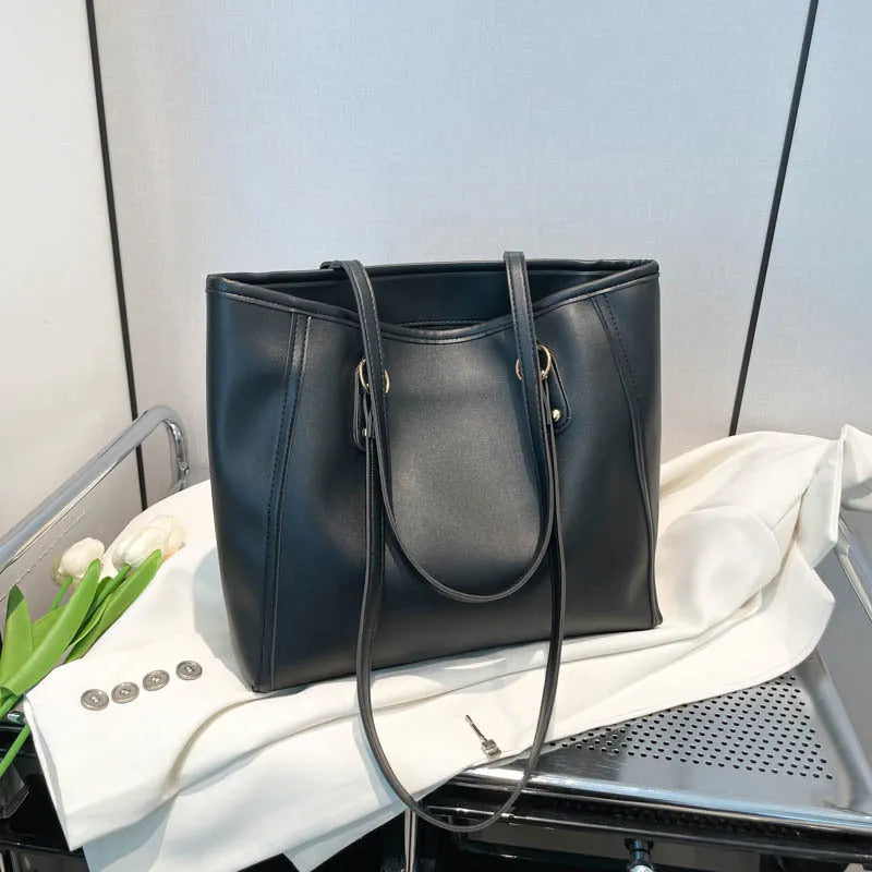 Large capacity PU tote bag in horizontal square shape with external slit pocket and internal organisation