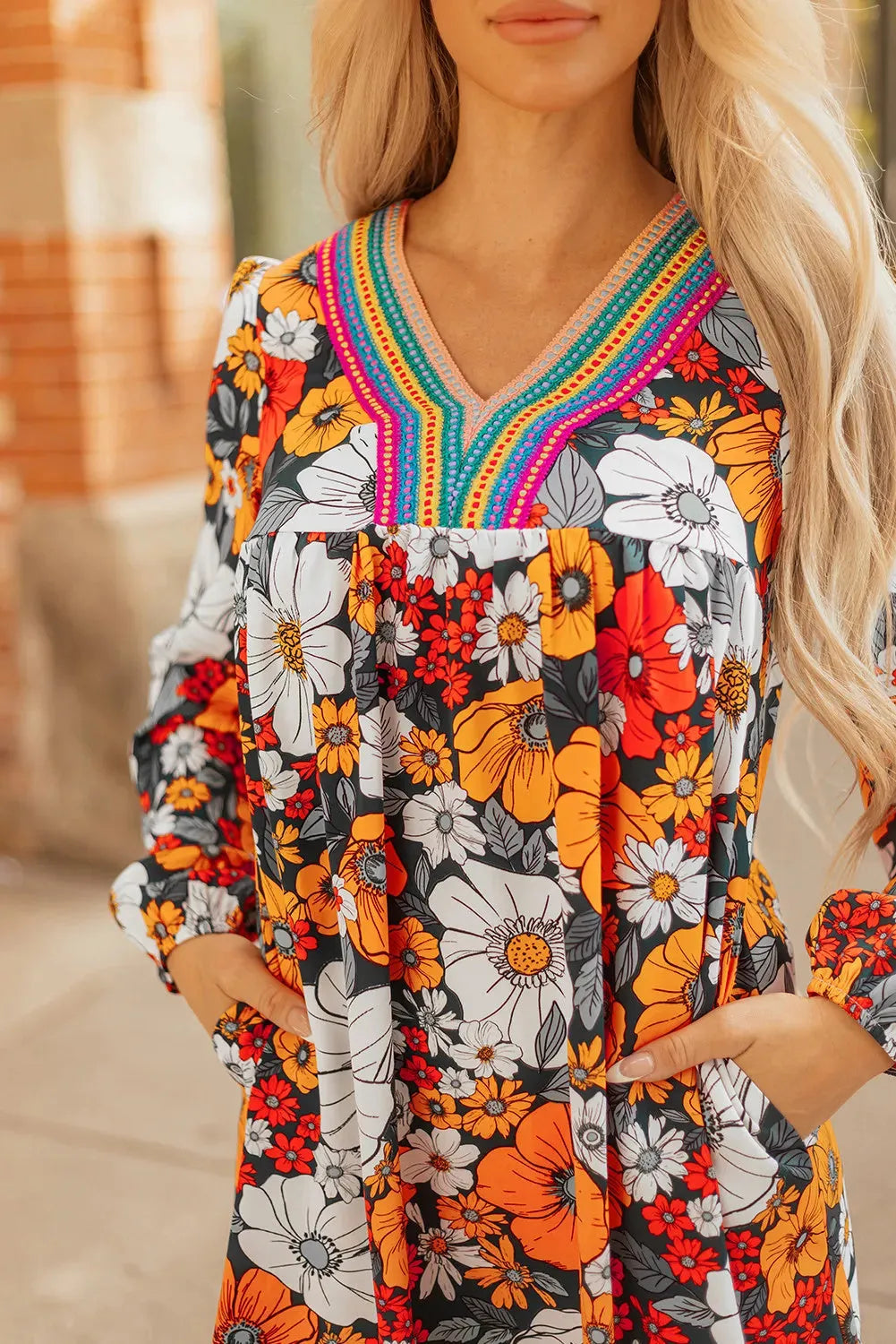Orange floral print mini dress with V-neck, long sleeves, and striped lace trim
