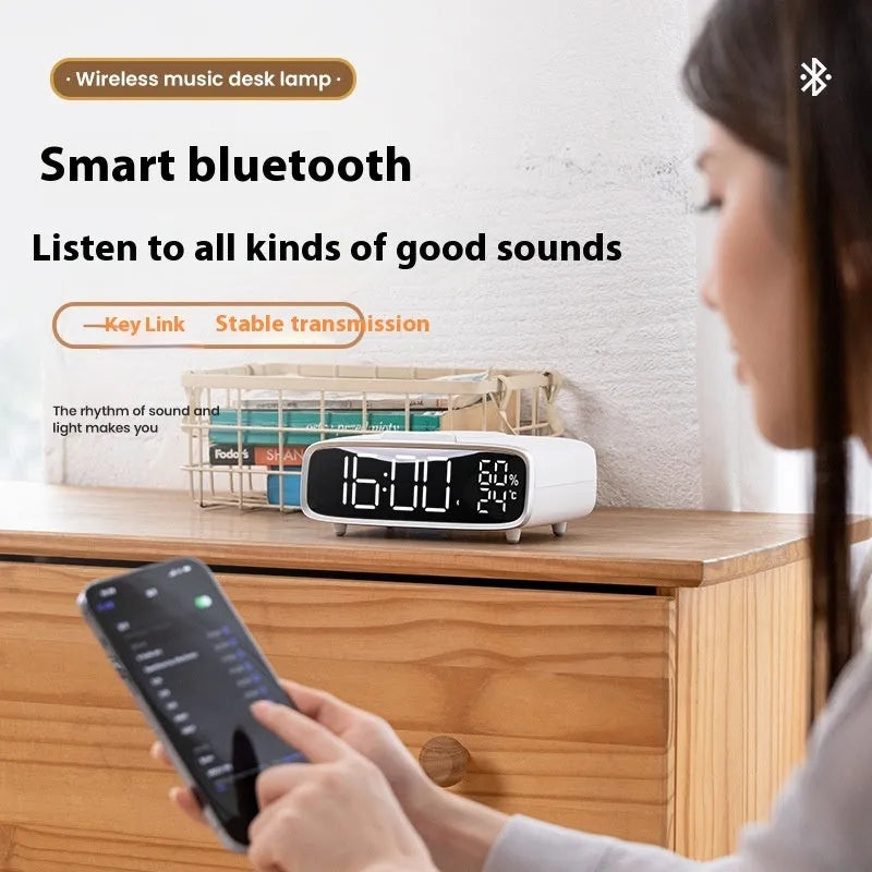 White Bluetooth speaker with wireless charging pad and integrated night lamp