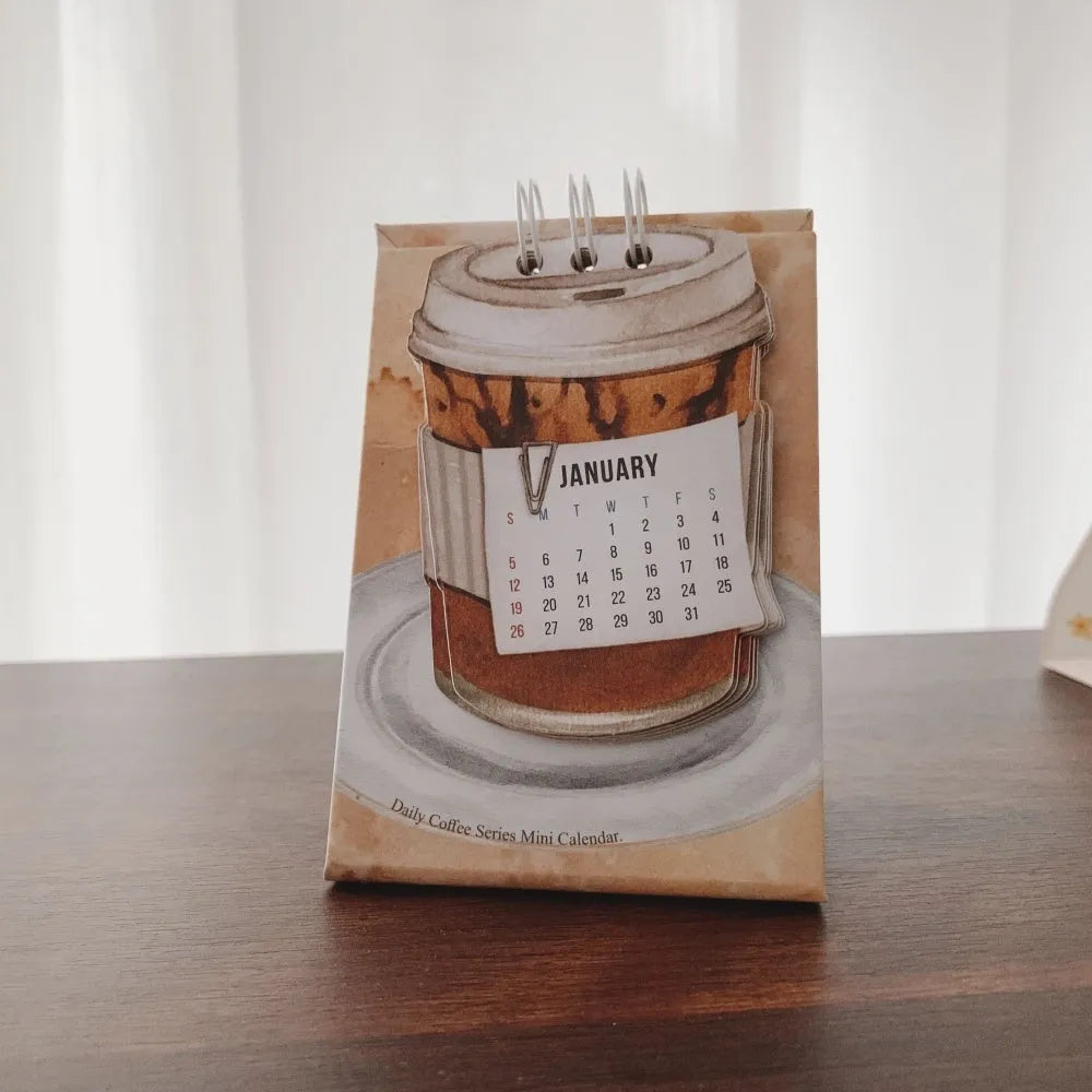 Coffee themed mini desk calendar for 2025 showing four different model designs on a desk.