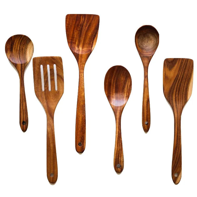 Seven-piece set of wooden cooking utensils including spoons and shovels on a kitchen counter.