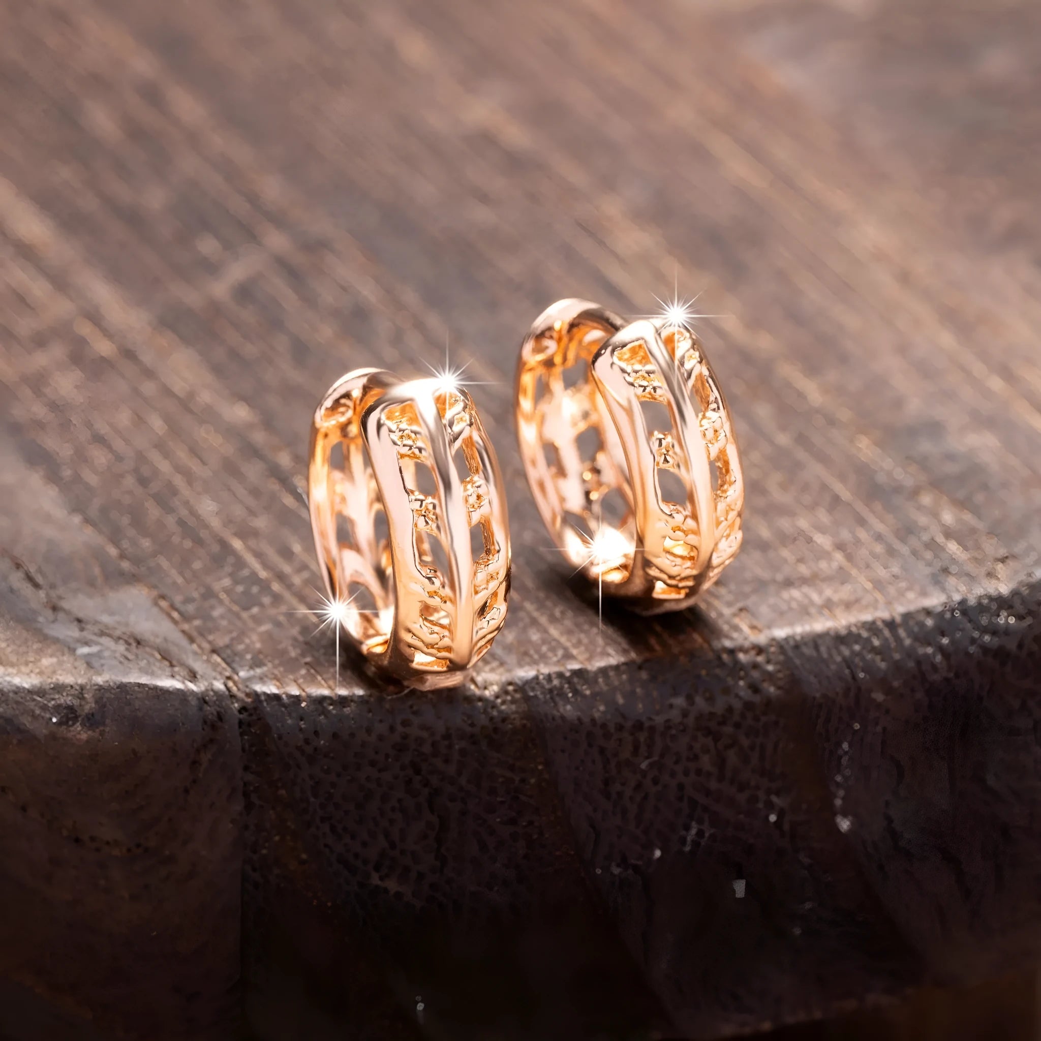 Copper hollowed-out leaf and heart shaped earrings with rose gold finish showing geometric patterns