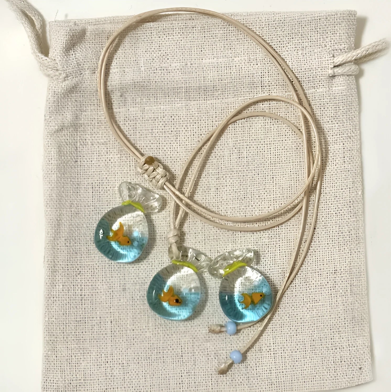 Women's joker charm necklace with coloured glaze pendant on a cotton and linen clavicle chain.