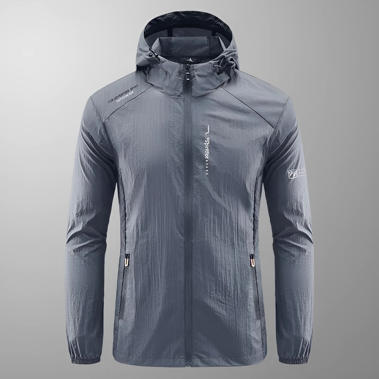Man wearing a lightweight grey hooded nylon summer jacket outdoors.