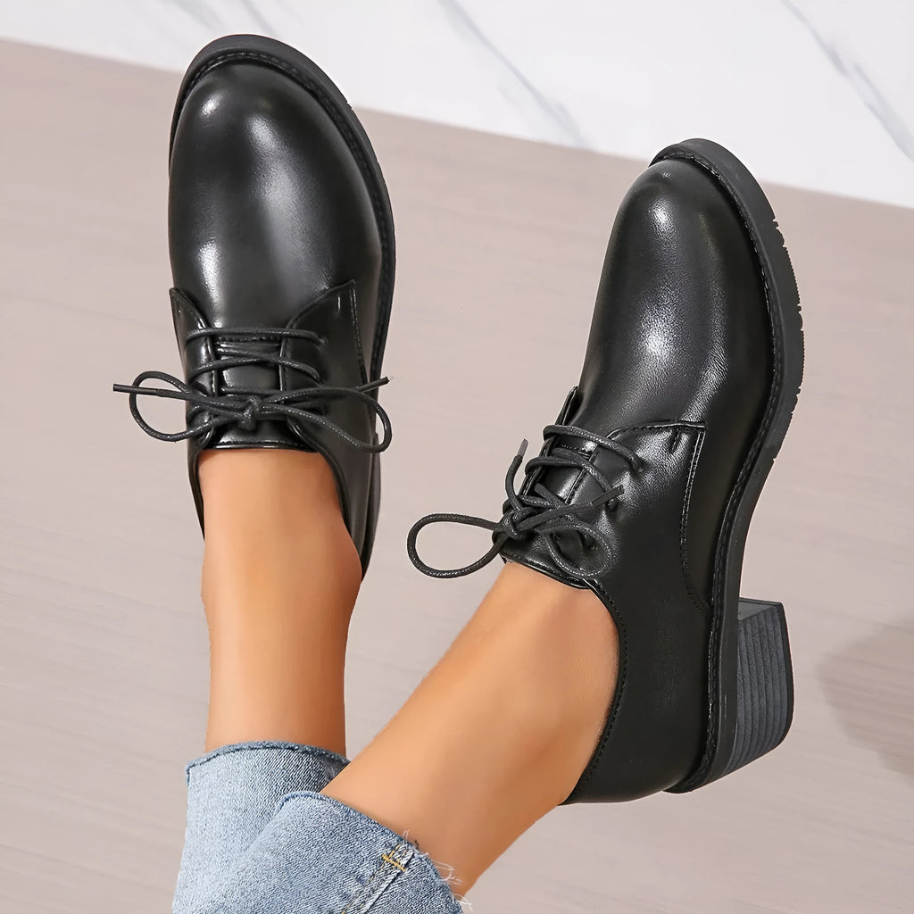 Black women's leather shoes with chunky heel, rubber sole, and low-top design for work and casual wear