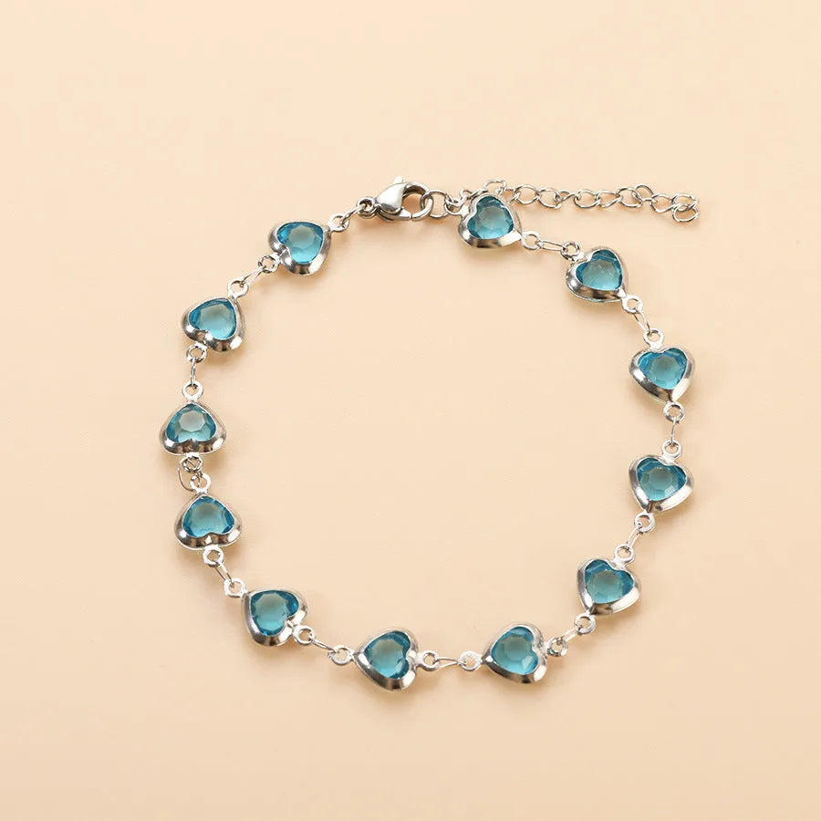 Devil's Eye geometric heart bracelet in stainless steel, shown in colourful, blue, green, or red electroplated finish
