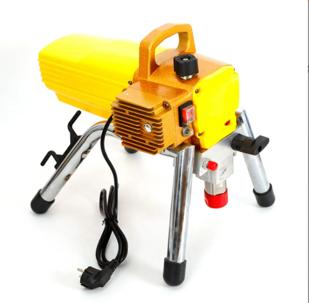 Blue portable electric airless paint spraying machine with spray gun, hose, and accessories on a workbench.