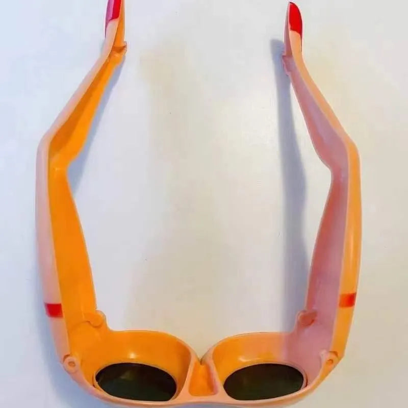 Orange plastic personality sunglasses for novelty leg and hip wear.