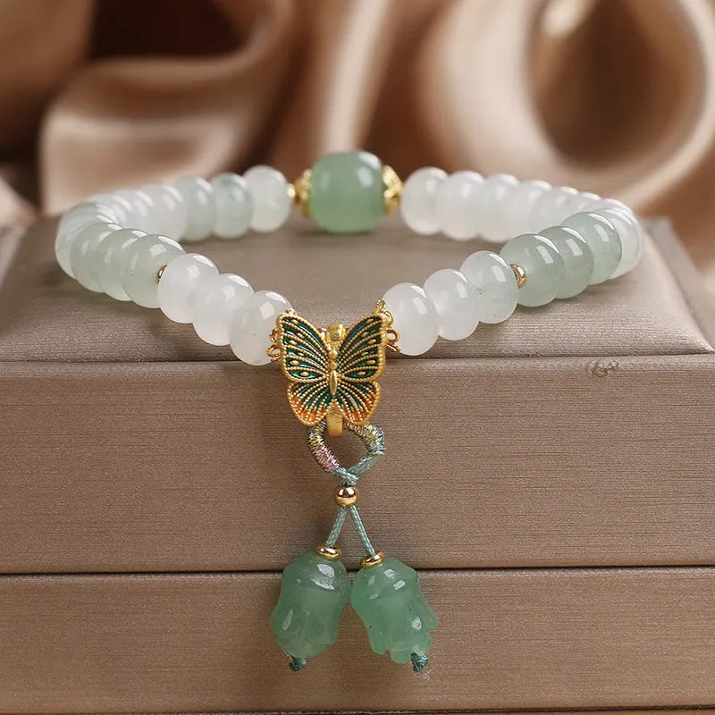 Green abacus bead bracelet for women with a butterfly tassel, pearls, and rhinestones