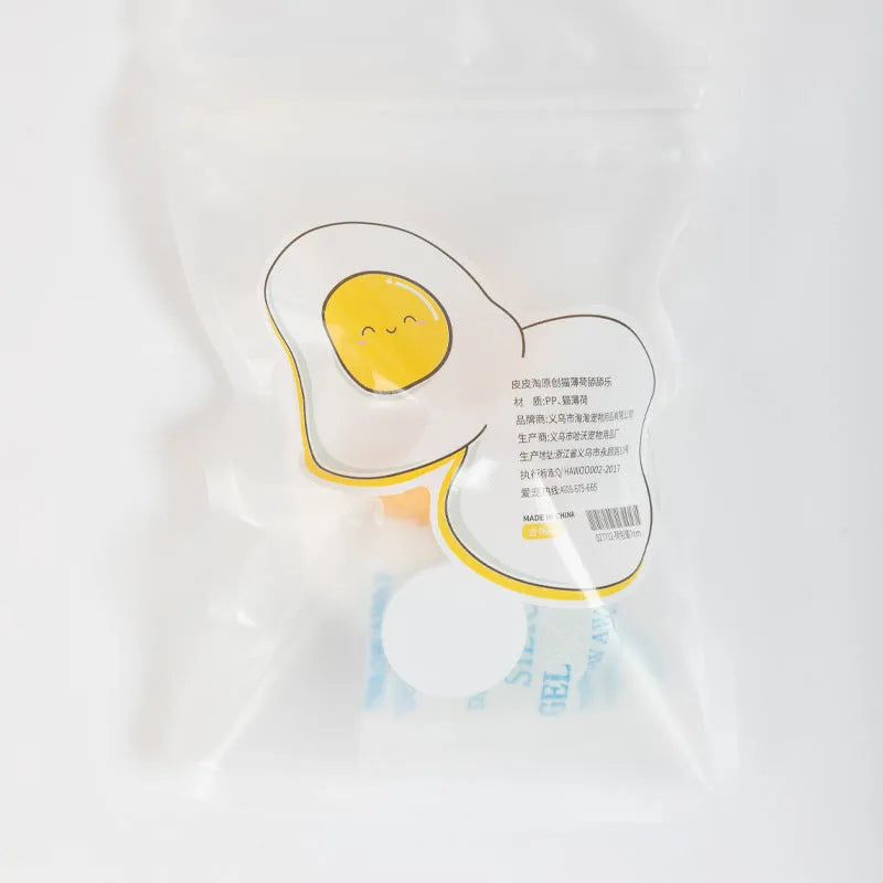 Interactive catnip ball toy with adhesive backing for walls, available in fried egg and poached egg designs