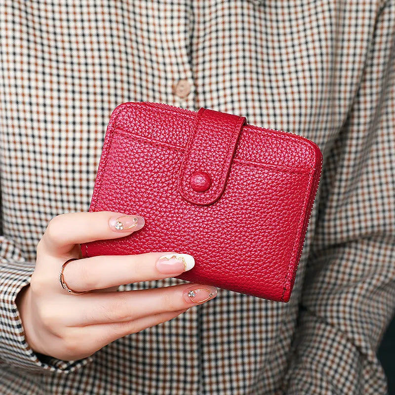 Beige women's short pu wallet with lychee pattern and sewing thread detail.