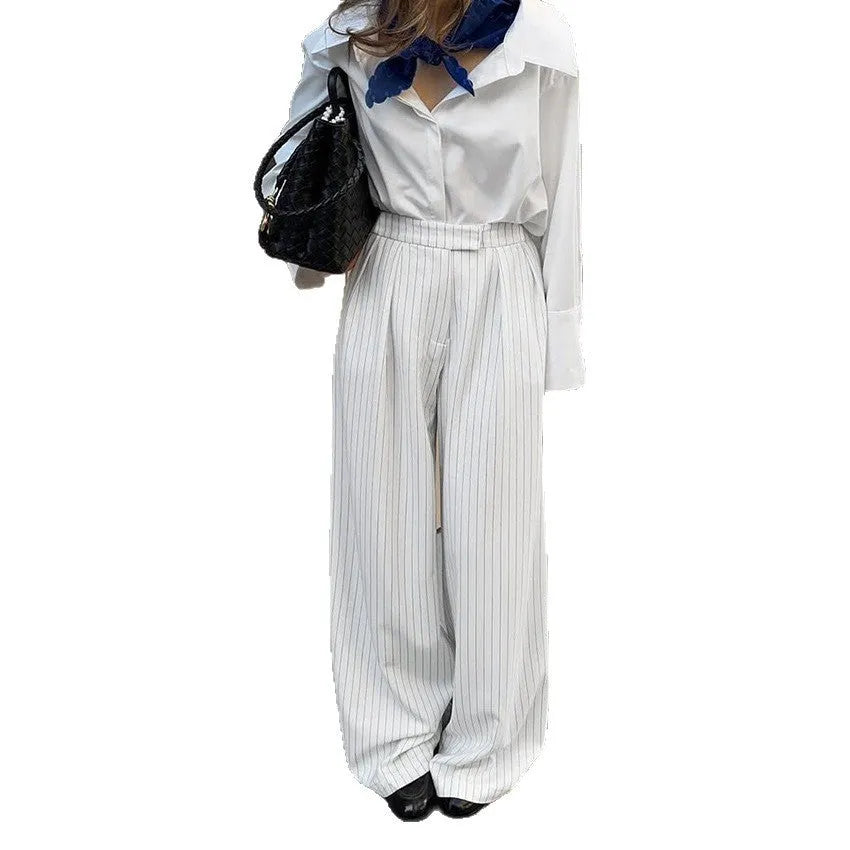 White striped women's wide-leg trousers with zip fastening and loose casual fit