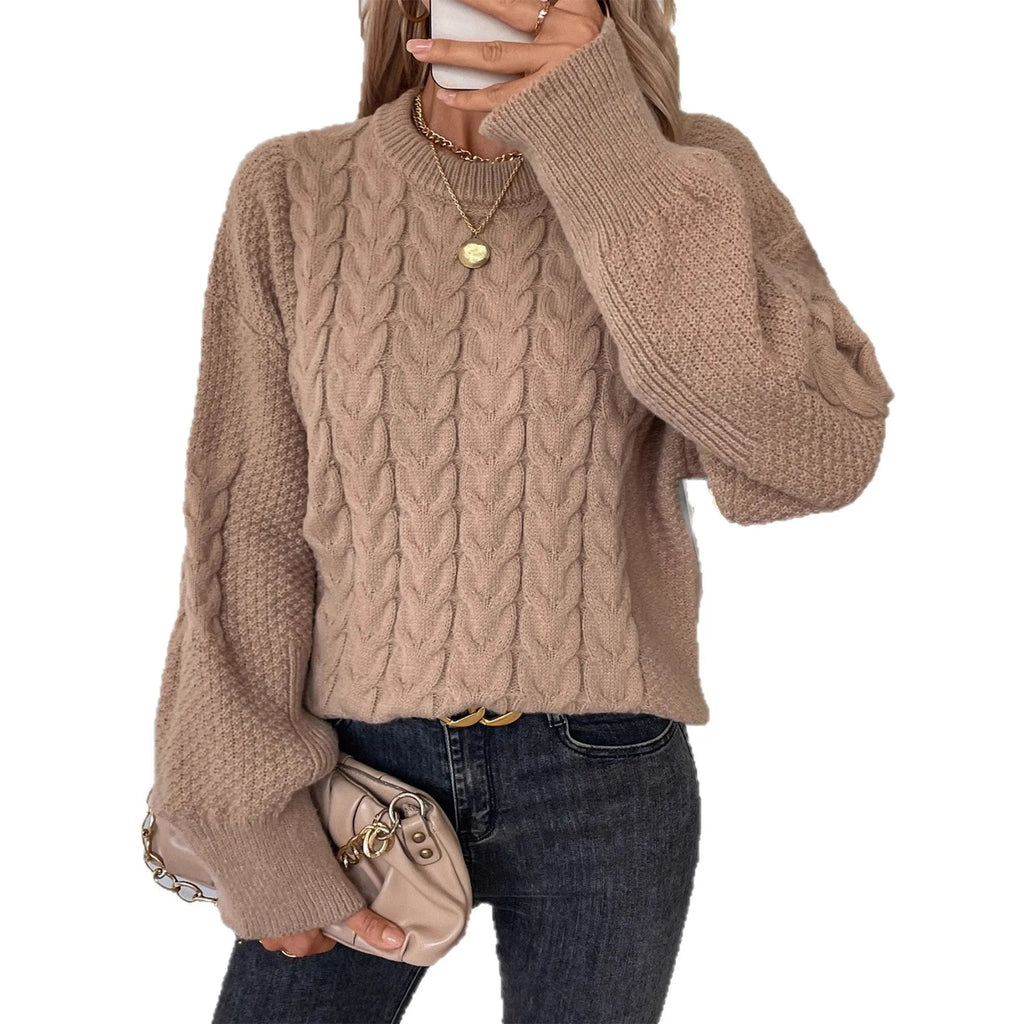 Women's loose beige round neck casual sweater with textured thread detail on a hanger.