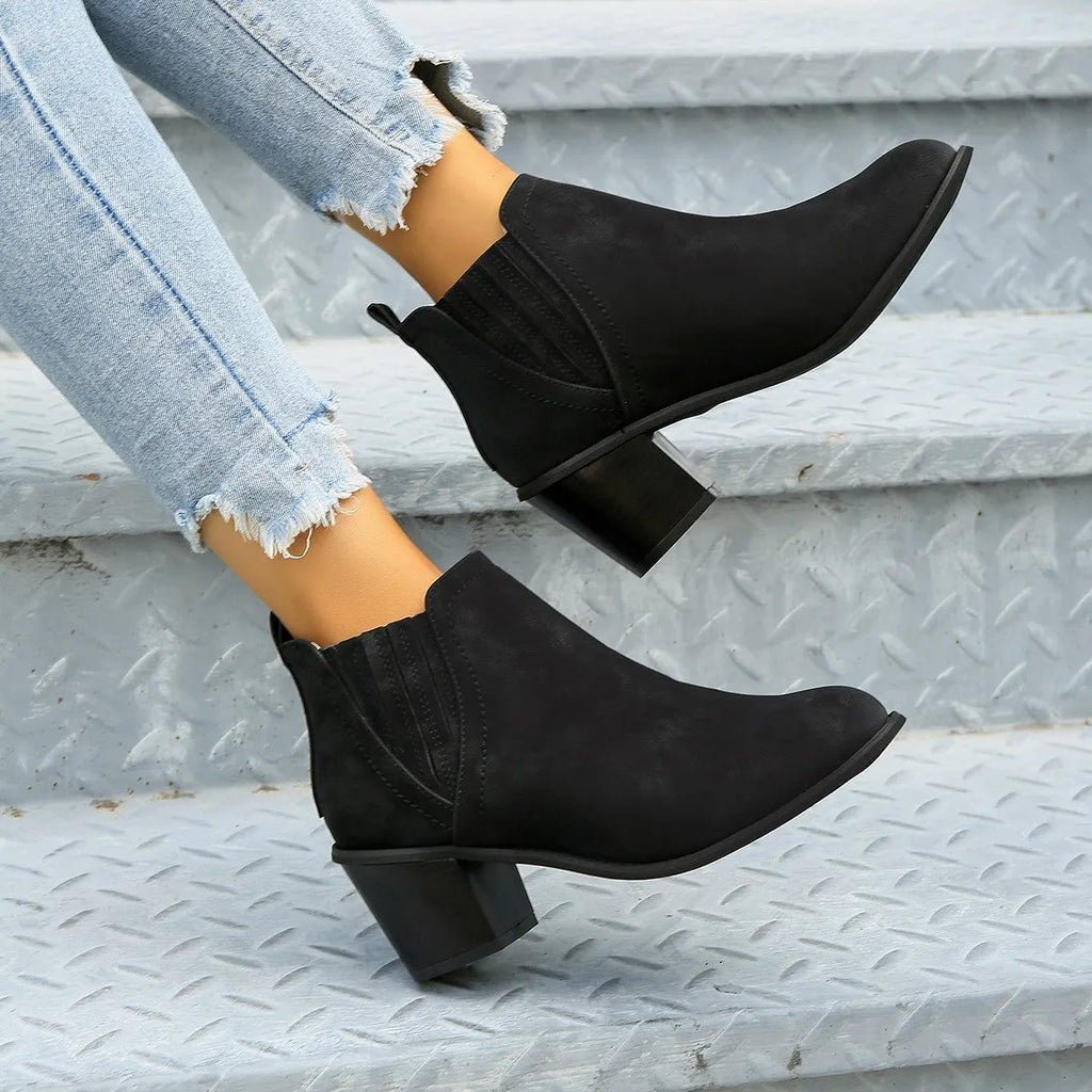 Women's black ankle boots with pointed toes and thick square low heels, slip-on design
