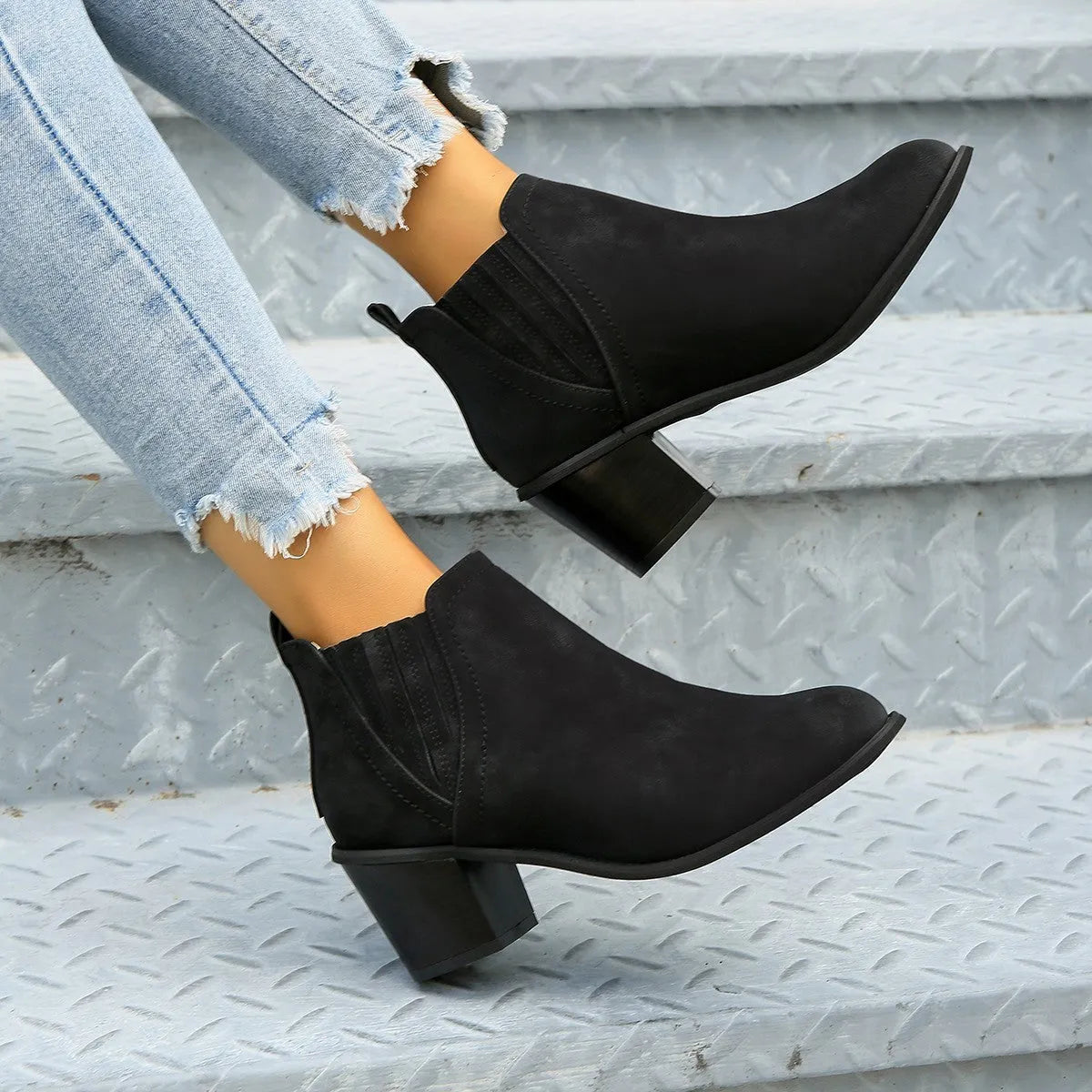 Women's black ankle boots with pointed toes and thick square low heels, slip-on design