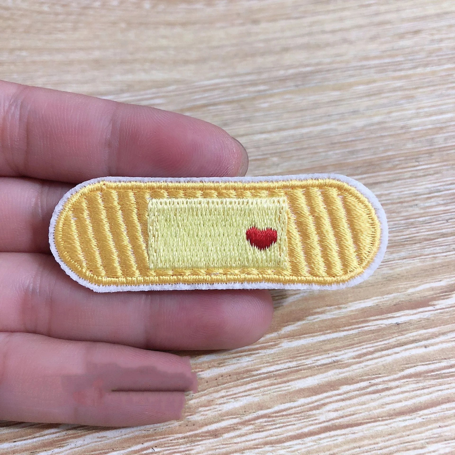 Ten computer-embroidered patch badges with adhesive backing for clothing decoration.