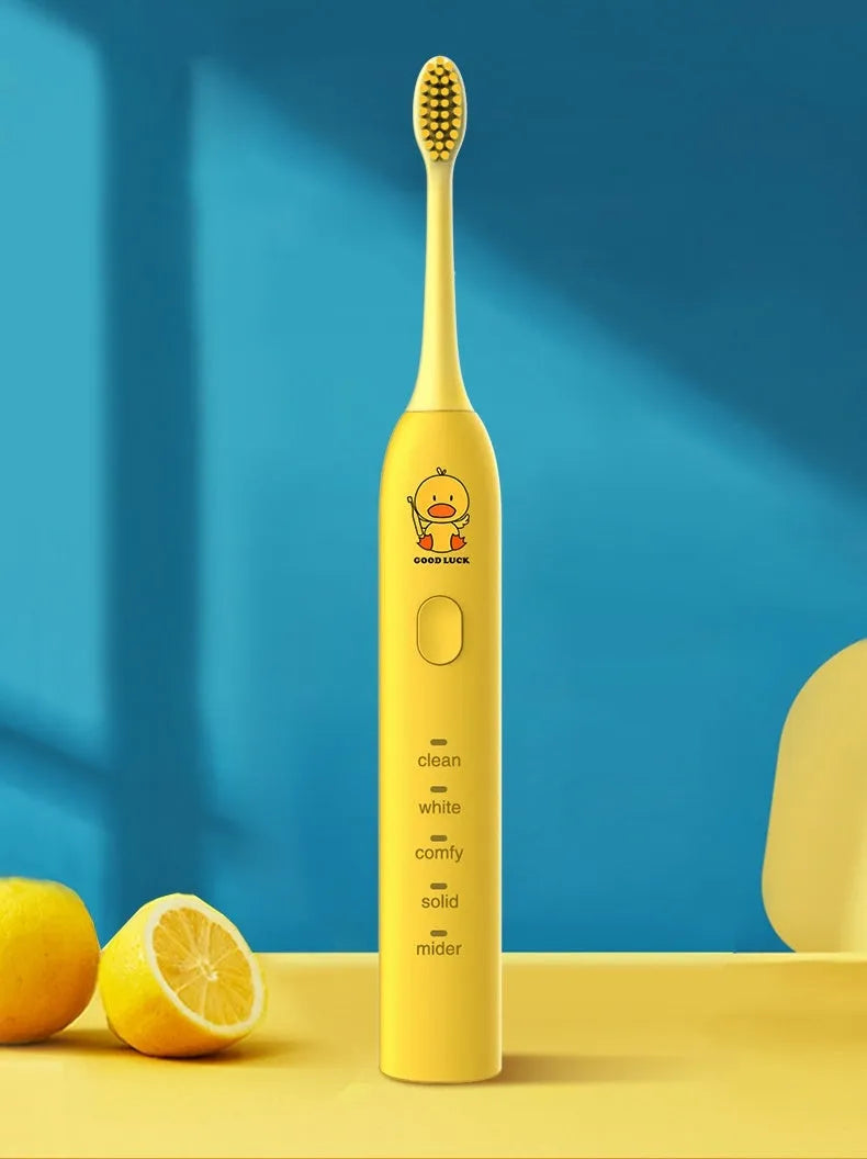 Yellow duck design USB rechargeable electric toothbrush with soft bristles on a bathroom counter.