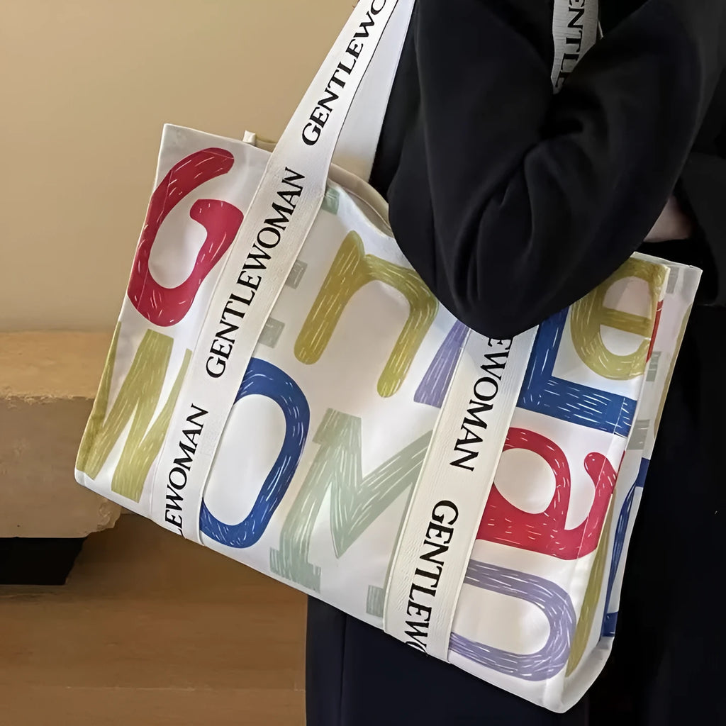 Large canvas tote bag with printed design, shown in available colour and pattern options.