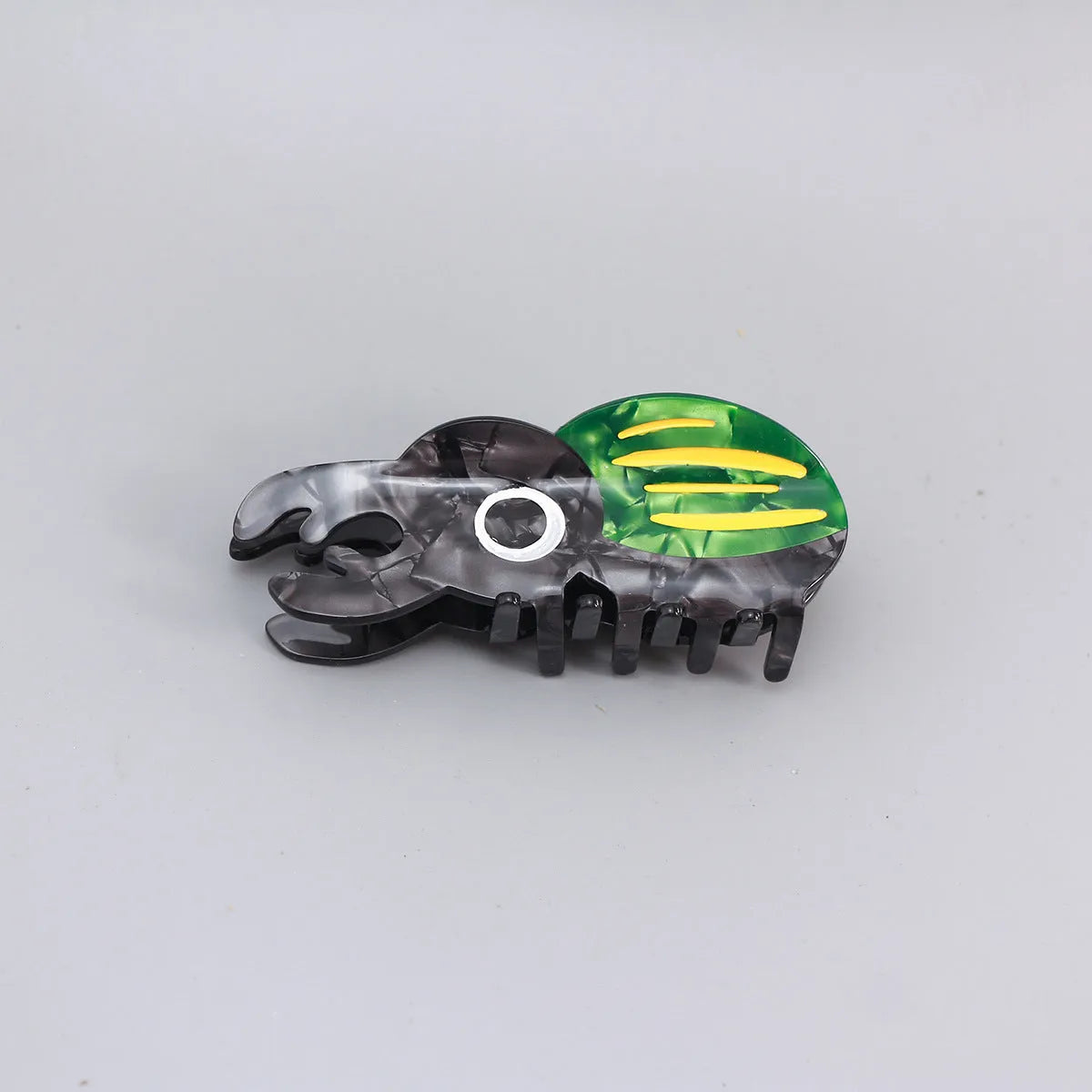 Cellulose acetate insect grip sheet with handmade beetle or caterpillar cartoon design