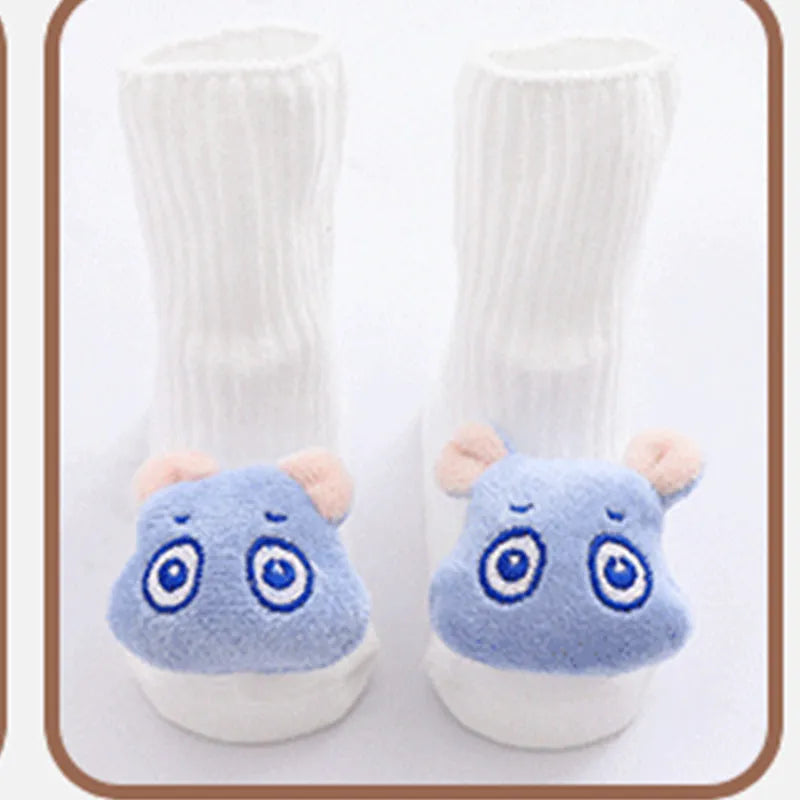 Cotton baby floor socks in various designs including blue bow and lion, showing sizes for infants 0-3 months