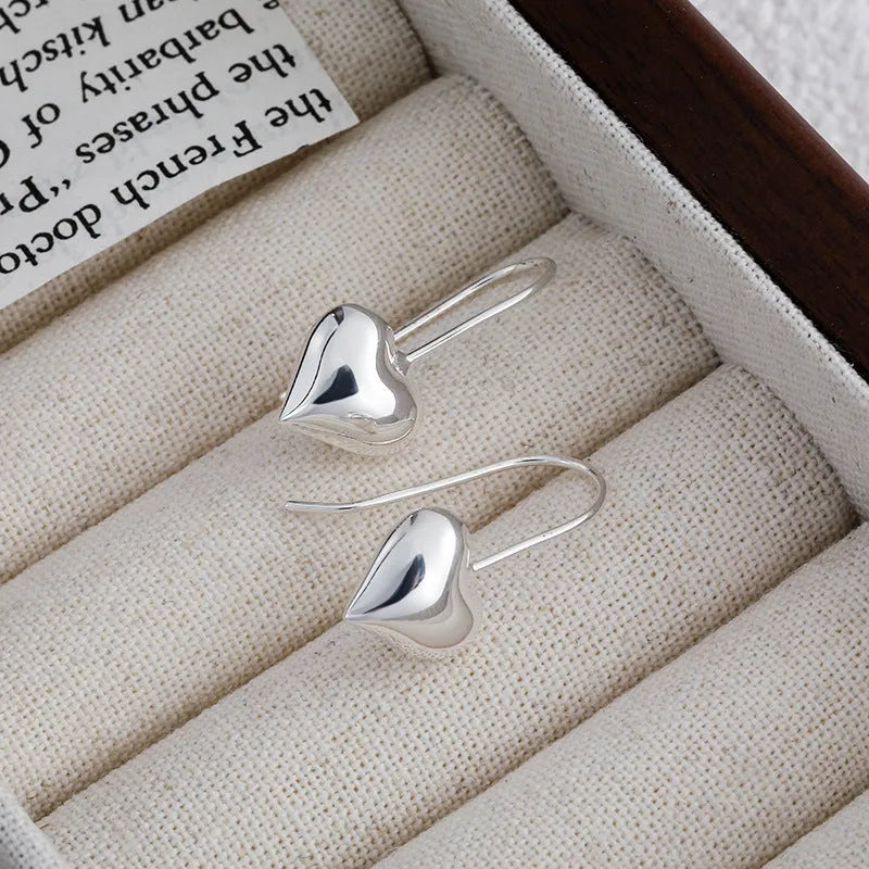 Silver Korean-style three-dimensional heart earrings with glossy finish and ear hook fastening
