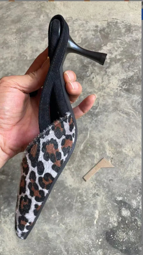 Leopard print suede women's sandals with a pointed toe and scattered decorative details on a high heel