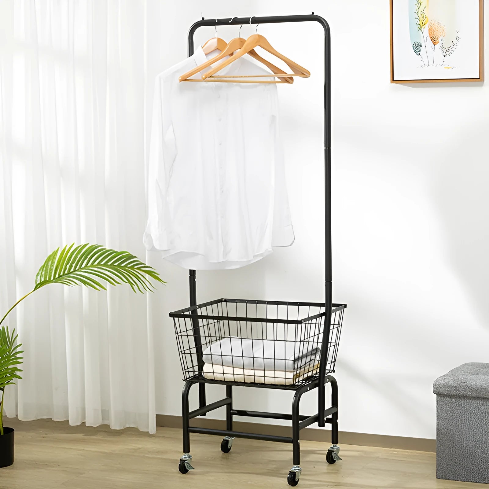 White single rod iron pulley storage car on wheels holding clothes hangers.