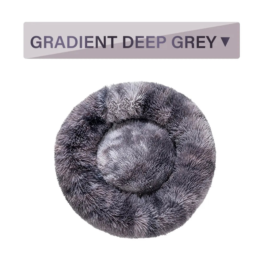 A round donut-shaped dog bed with a raised plush rim, shown in a light grey colour.
