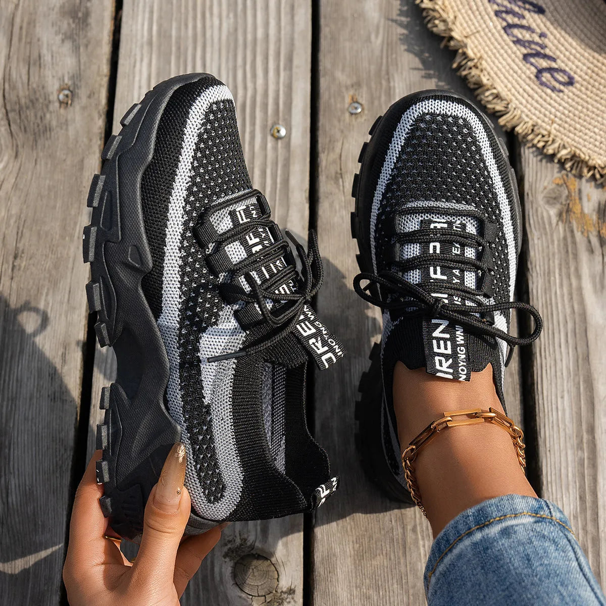 Women's Flyknit mesh lace-up sneakers in a multi-tonal colour with a flat rubber sole.